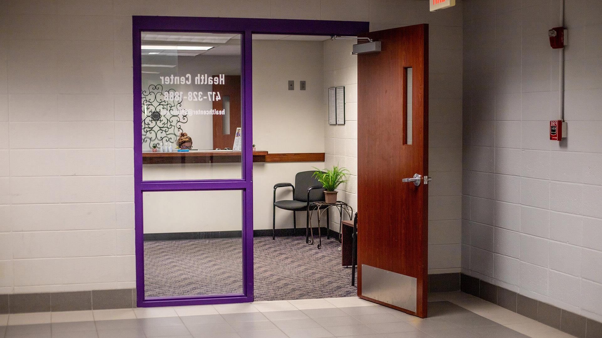 campus nurse and office assistant; front entrance view of Killian Health Center